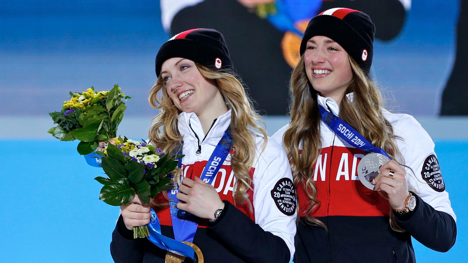 Gold medalist Justine Dufour-Lapointe of Canada poses with silver medalist Chloe Dufour-Lapointe. The sisters competed in the women's freestyle skiing moguls at the Sochi Winter Olympics. A Canadian TV host criticized how CBC announcers were pronouncing t
