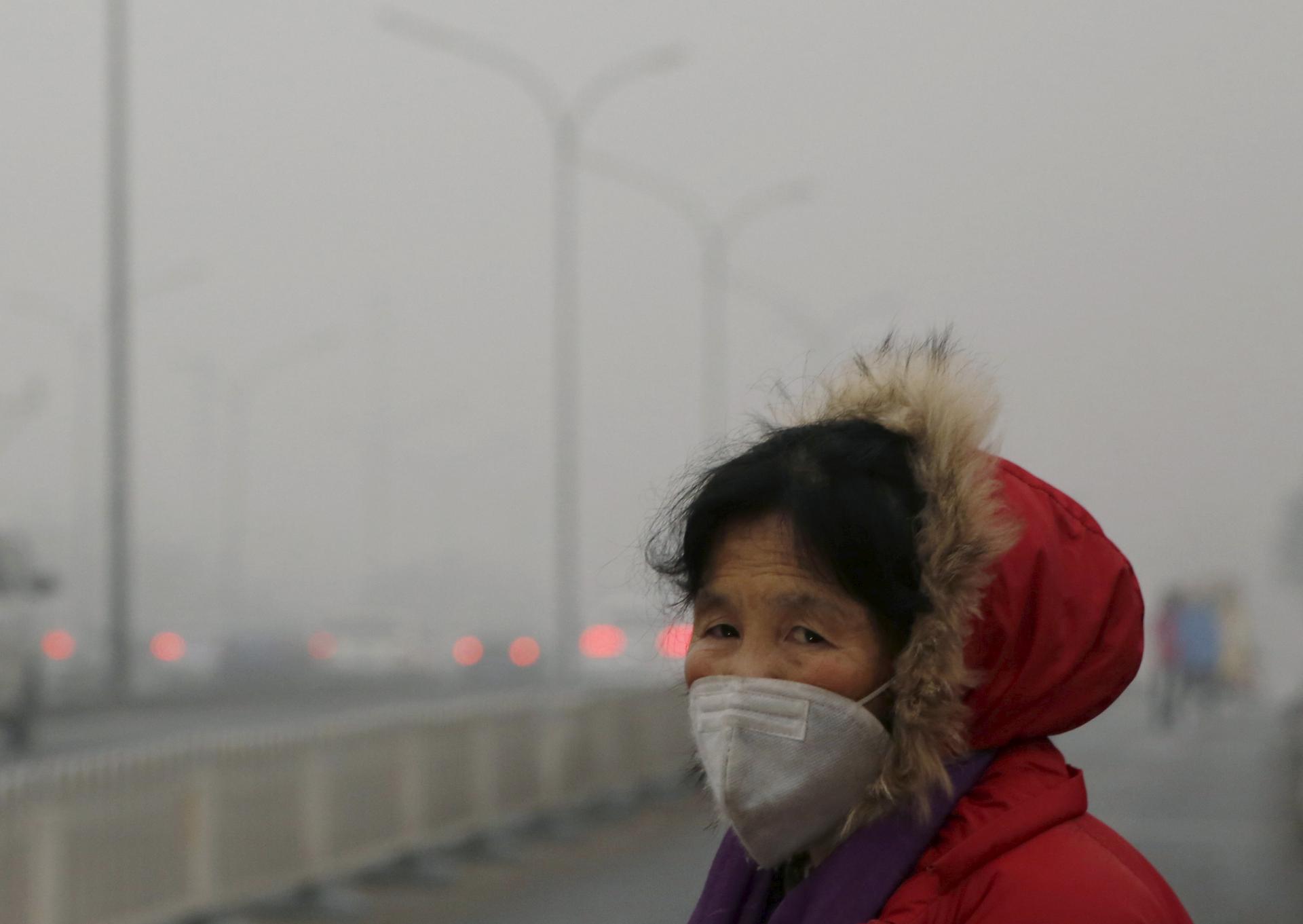 A woman wears a protective mask on one of the worst polluted days in Beijing.