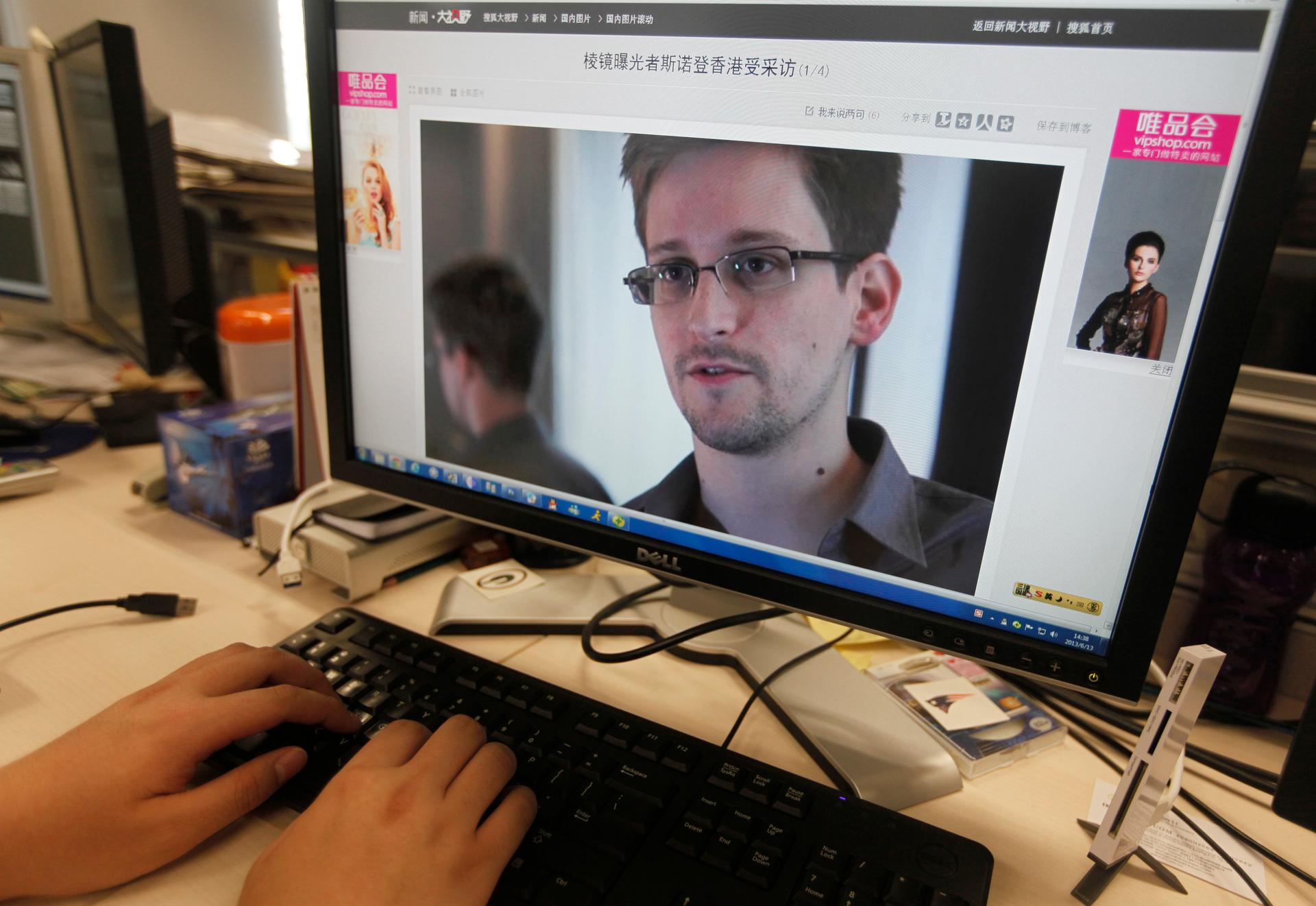 A picture of Edward Snowden, a contractor at the National Security Agency (NSA), is seen on a computer screen displaying a page of a Chinese news website.