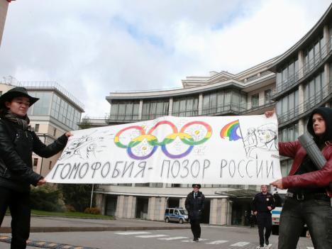 Gay rights activists in Moscow hold a banner protesting a ban on gay pride parades during the Sochi 2014 Winter Olympics.
