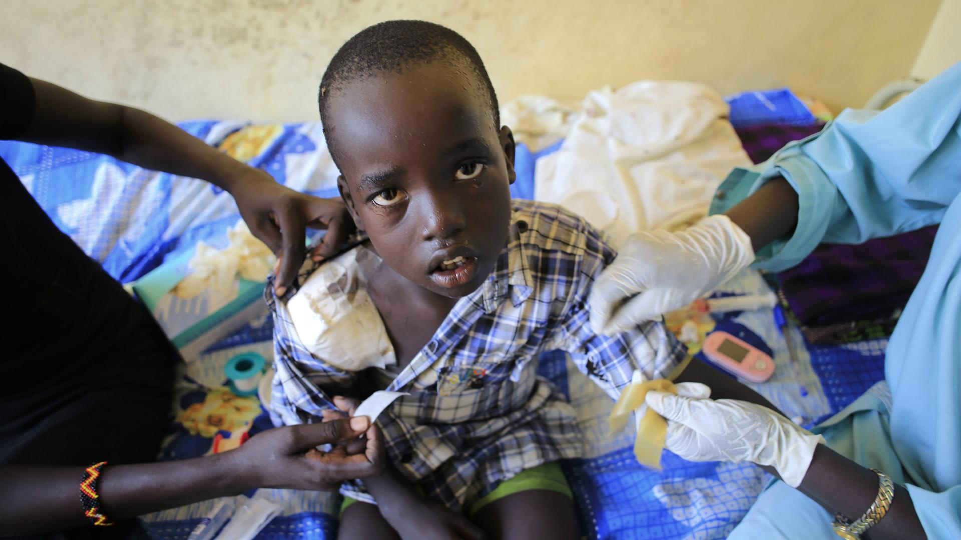 A wounded child undergoes medical treatment in Juba, South Sudan, Dec. 28, 2013.