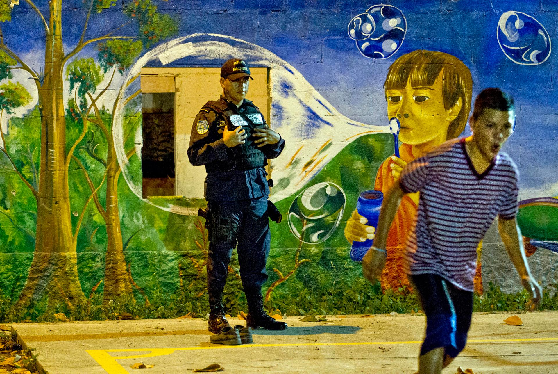 Honduran police officer Marvin Castro patrols this once very dangerous neighborhood of Chamelecón in San Pedro Sula, Honduras.