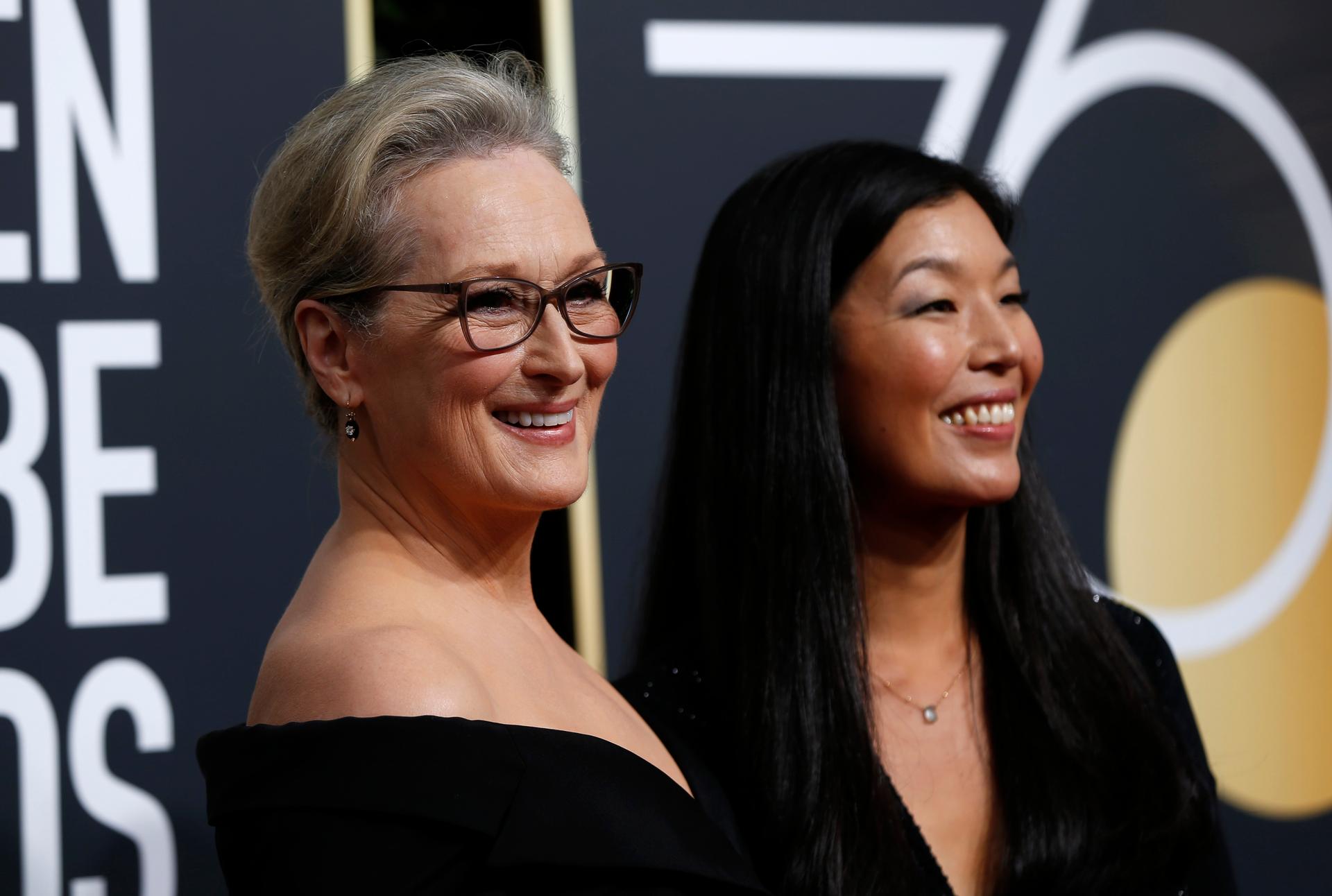 Actress Meryl Streep (L) and the director of the National Domestic Workers Alliance, Ai-jen Poo, at the 75th Golden Globe Awards.