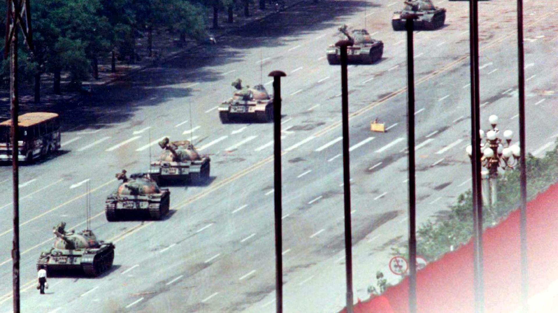 A Beijing citizen stands in front of a row of Chinese tanks on the Avenue of Eternal Peace in this June 5, 1989 file photo during the crushing of the Tiananmen Square uprising. 