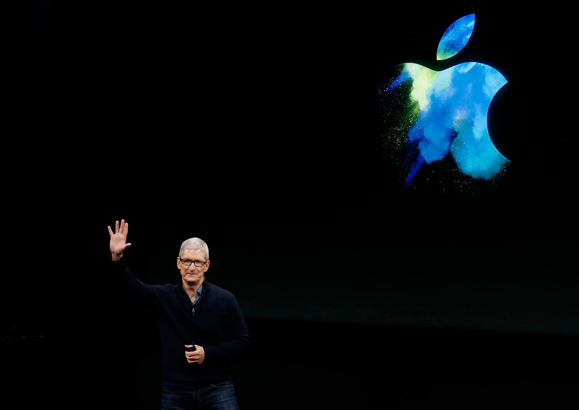 Apple CEO Tim Cook waves