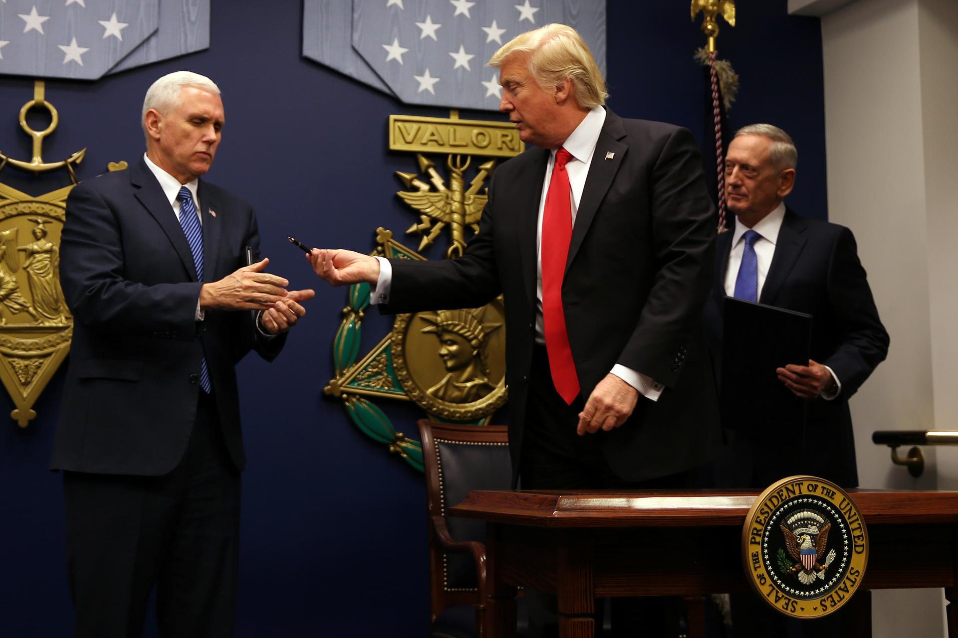 US President Donald Trump reacts after signing an executive order to impose tighter vetting of travelers entering the United States, at the Pentagon in Washington, January 27, 2017.