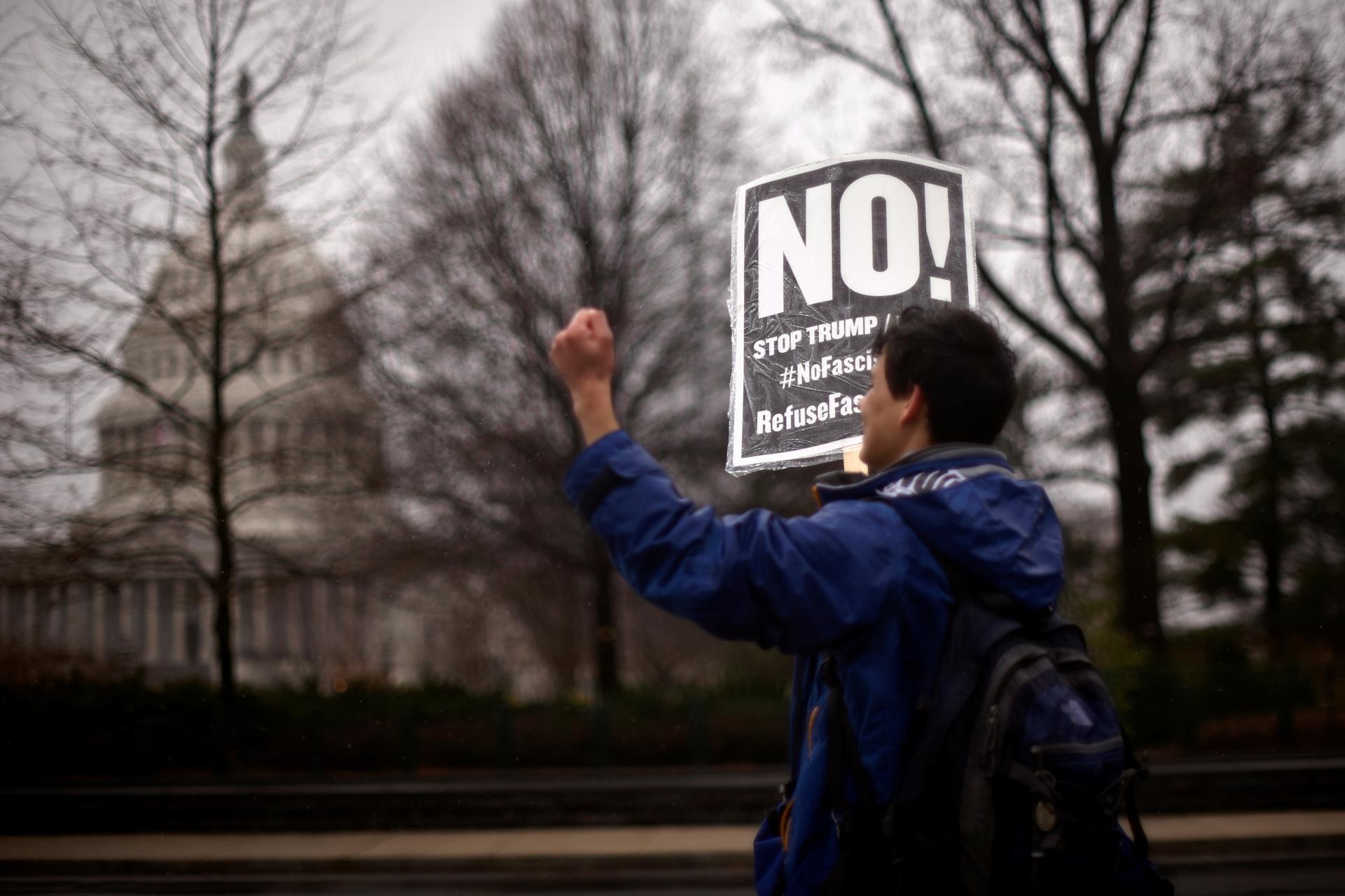 A protester organized by RefuseFascism.org participates in a demonstration outside the US Supreme Court