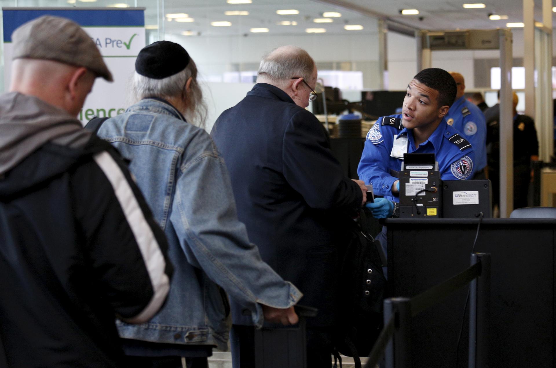 Travelers make their way through a TSA checkpoint at Reagan National Airport in Washington