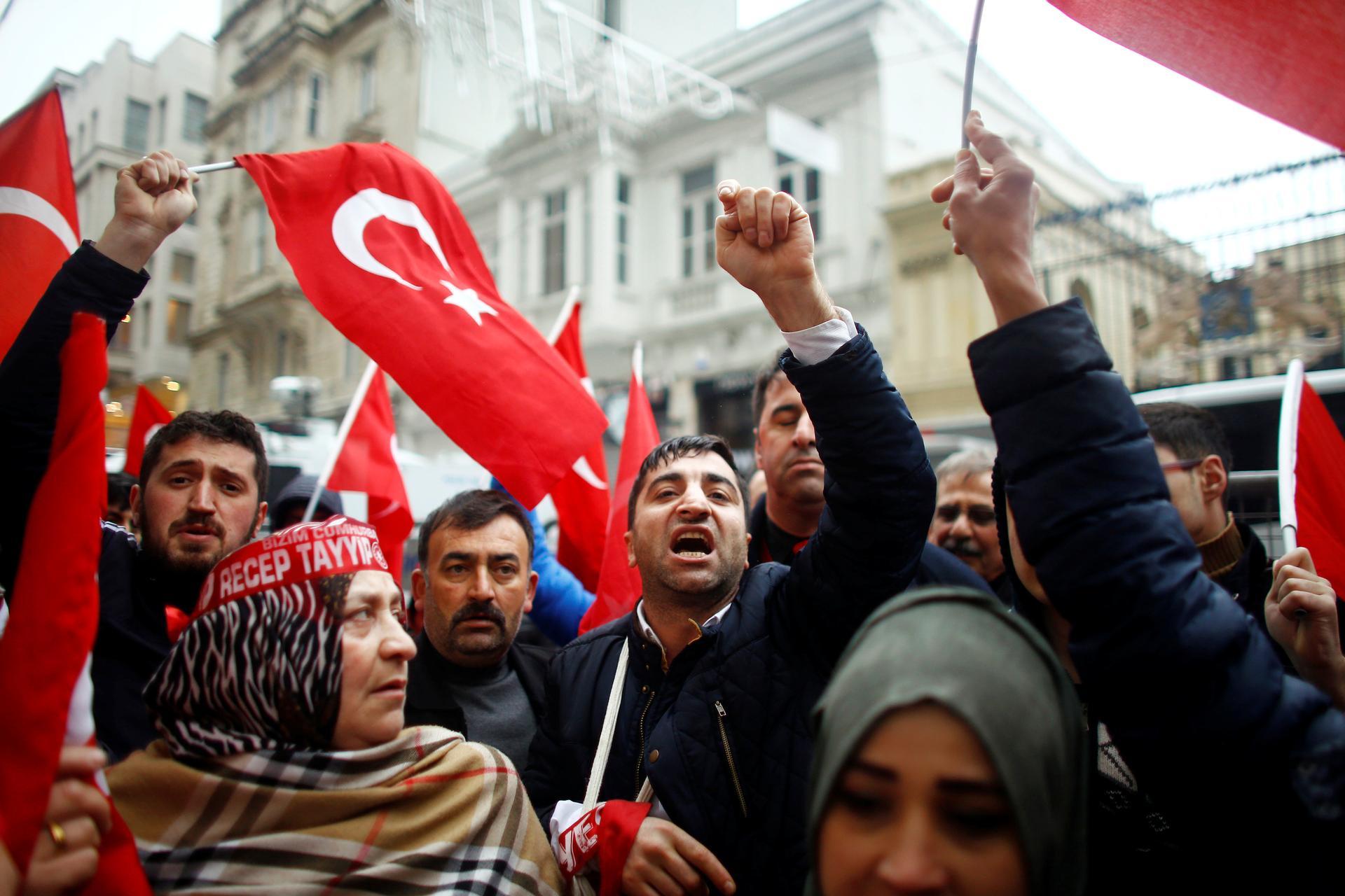 People shout slogans during a protest in front of the Dutch Consulate in Istanbul, Turkey, March 12, 2017.