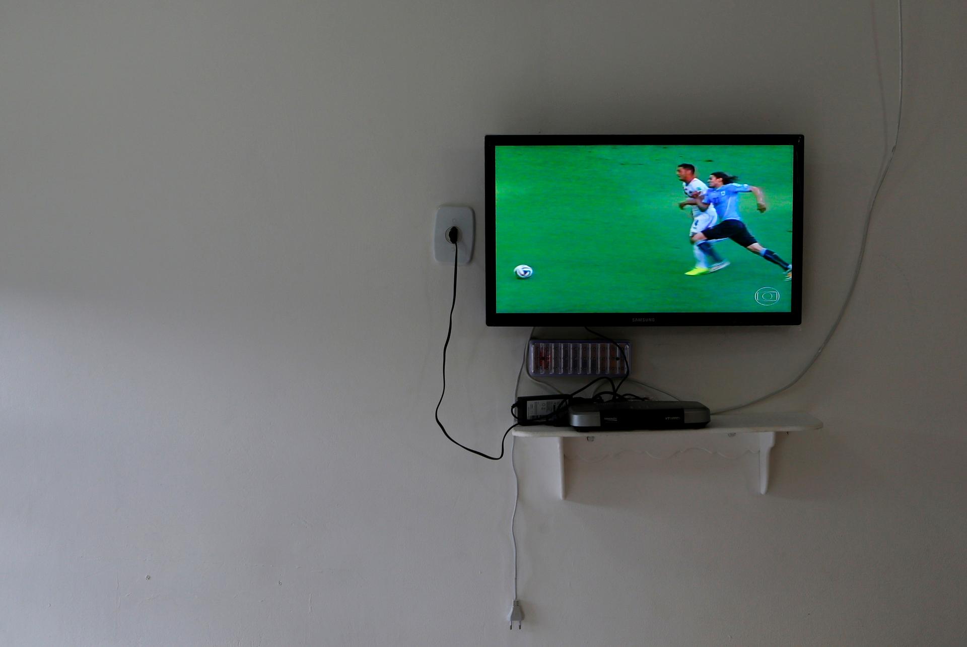 A TV plays a soccer match
