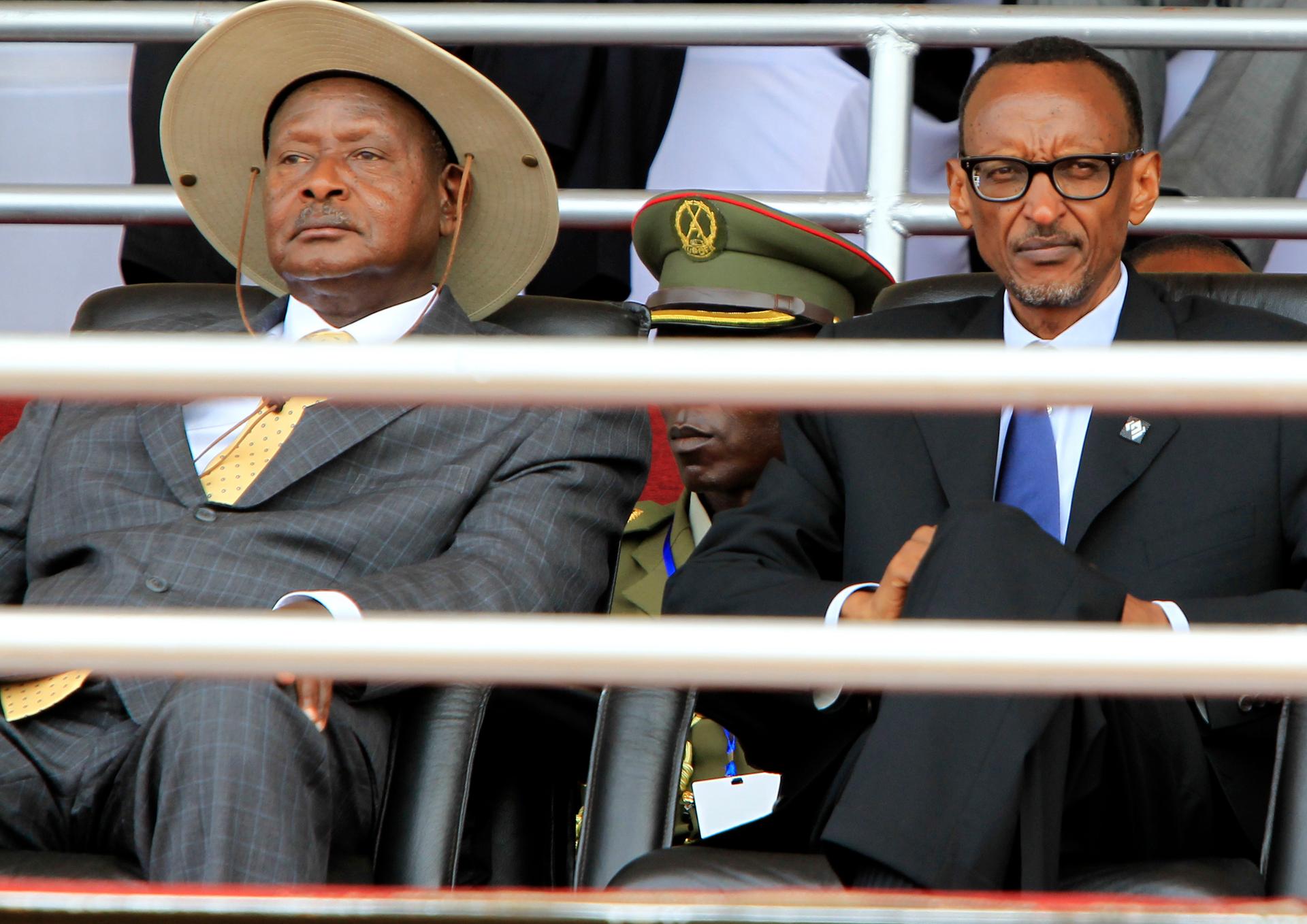 Rwandan President Paul Kagame (R) and his Ugandan counterpart Yoweri Museveni follow the proceedings of the 20th anniversary commemoration of the Rwandan genocide, in Kigali April 7, 2014. An estimated 800,000 people were killed in 100 days during the gen