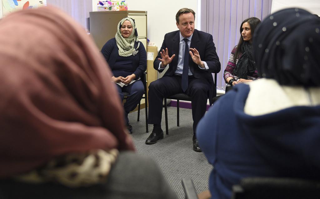 UK Prime Minister David Cameron speaks with women attending an English language class during a visit to the Shantona Women's Centre in Leeds, Britain, on Jan. 18, 2016.
