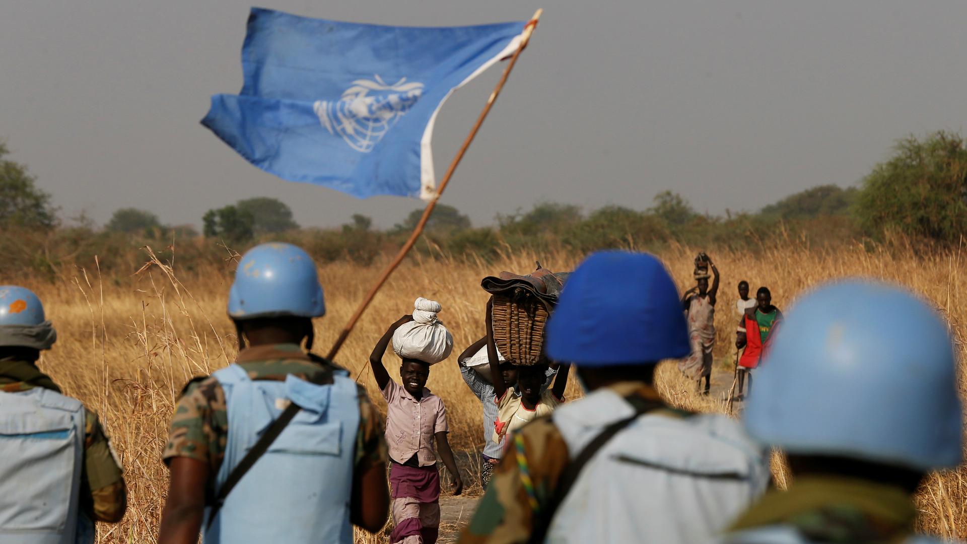 United Nations peacekeepers meet women and children on their path during a patrol near Bentiu, northern South Sudan, Feb. 11, 2017.