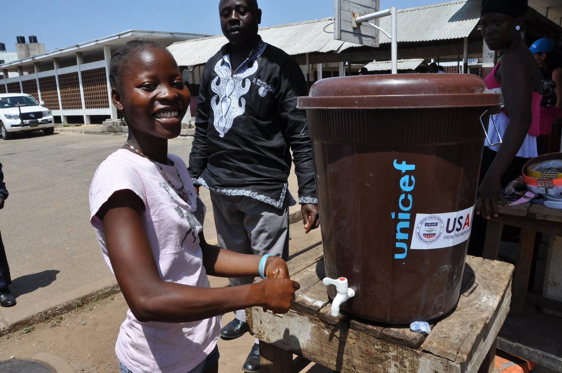 Student at Gibson High School in Monrovia, Deborah Natt,16, is smiling to be back at school. At every entrance there is a handwashing station.