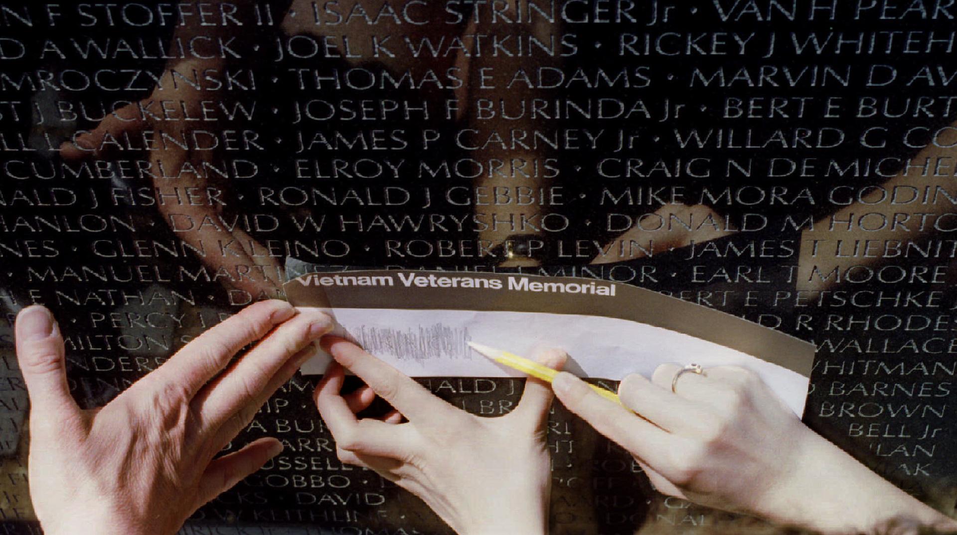 Relatives etch the name of Craig Swagler at the Vietnam Veterans Memorial