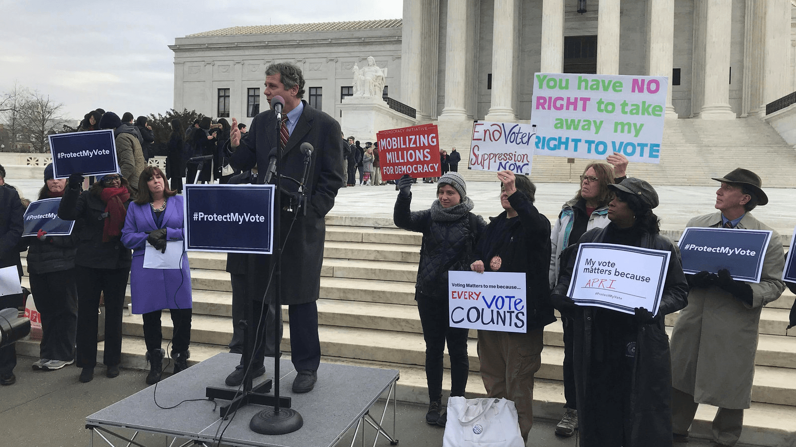 US Senator Sherrod Brown (D-OH) addresses a rally ahead of arguments in a key voting rights case involving a challenge to the Ohio’s policy of purging infrequent voters from voter registration rolls outside the US Supreme Court in Washington, Jan. 10, 201