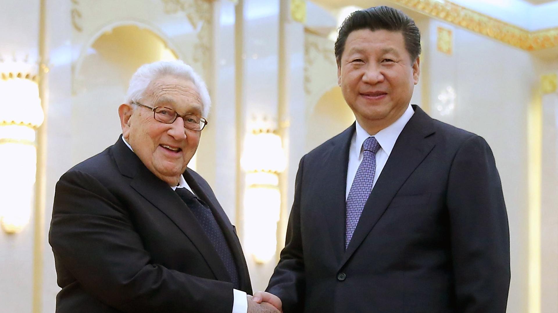 Chinese President Xi Jinping (R) shakes hands with one of American history’s greatest statesman, Henry Kissinger, at the Great Hall of the People in Beijing on March 17, 2015.