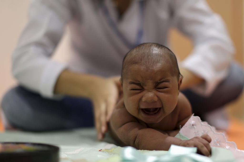 A baby born with microcephaly reacts to stimulus during an evaluation session with a physiotherapist at the Altino Ventura rehabilitation center in Recife, Brazil on January 28, 2016.
