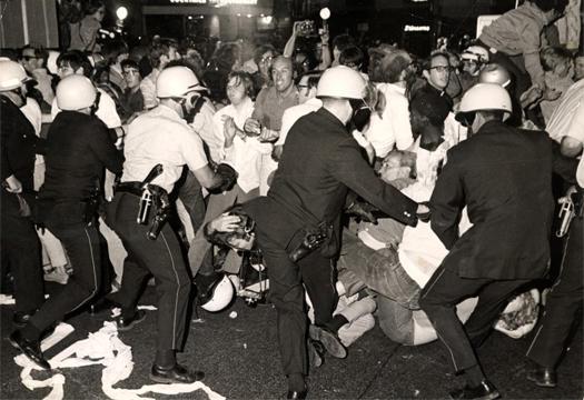 Police wearing helmets clash with protestors on the streets of Chicago at the Democratic National Convention in 1968