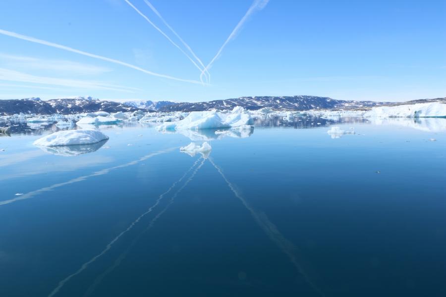 Jet contrails over the Sermilik fjord. Oceanographer Fiamma Straneo has found that warming water from the Atlantic is finding its way into this and other Greenland fjords, likely melting them from below and contributing to the loss of ice and flow of fres