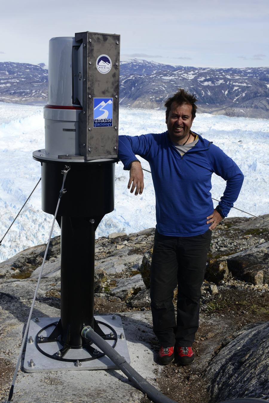 Glaciologist Gordon Hamilton from the University of Maine standing next to a new state-of-the-art laser his team has just installed on the rim of Greenland's Helheim glacier. The laser will scan the glacier in unprecedented detail and provide valuable clu