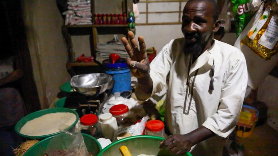 Kandwe village shopkeeper Pandu Matti Salum says says his new solar panel and LED lights have made his store has a nighttime gathering place and increased his sales. With the new income he says he plans to expand his shop, marry a third wife and have more