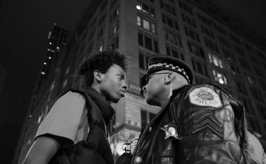 Lamon Reccord stares down a police sergeant during a protest following the fatal shooting of Laquan McDonald by police in Chicago, Illinois, USA, 25 November 2015.