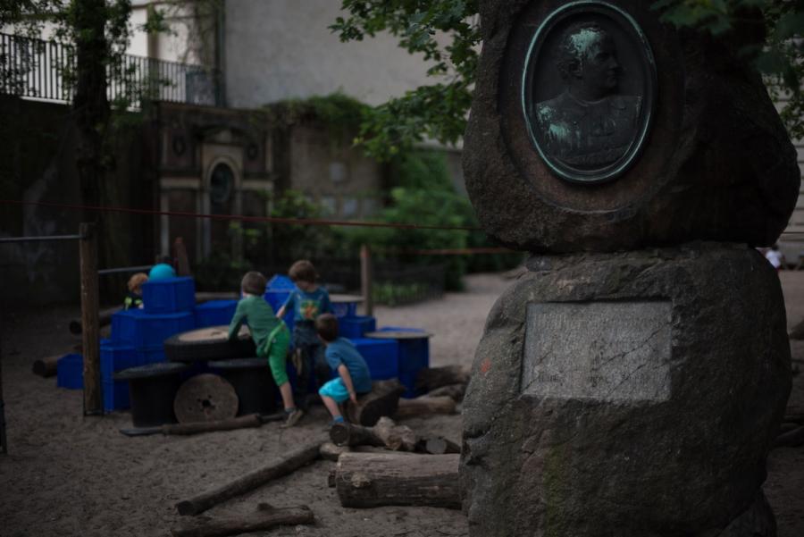 Children climb on a construction near a gravestone in the playground of the Sophienkirche day-care center in Berlin, Germany. The day-care is located on the grounds of the Sophienkirche church, and it’s playground occupies a space that was once the parish