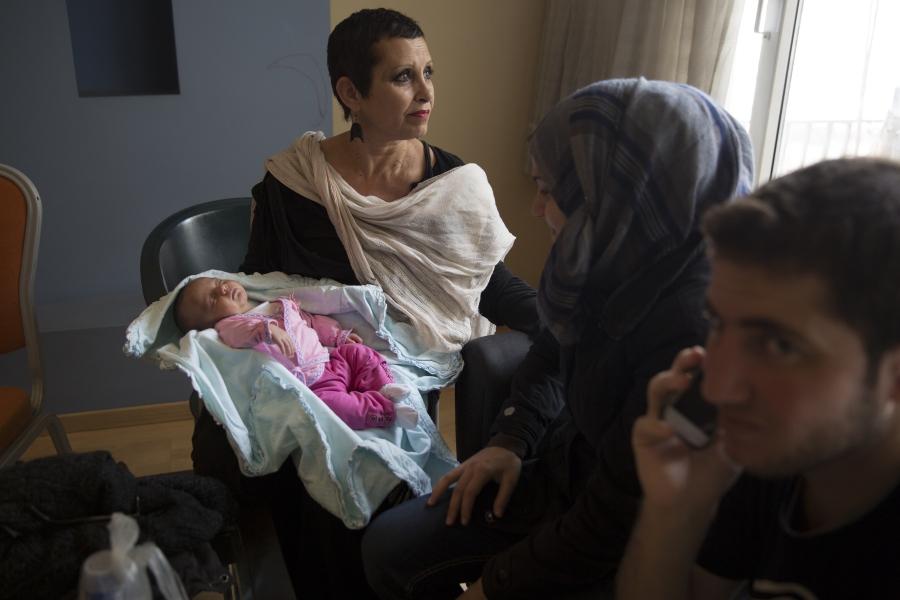 Kaiti Aravandinou, a Greek woman, holds one-month-old Miriyam