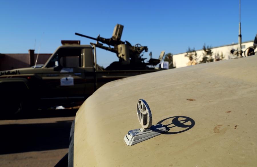 Toyota pickup trucks mounted with anti-aircraft machine guns outside of a militia base in Tripoli housing fighters from the city of Misrata.