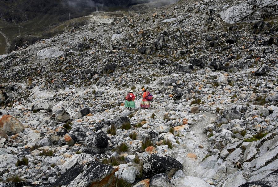 Aymara indigenous women descend after practicing on a glacier at the Huayna Potosi.