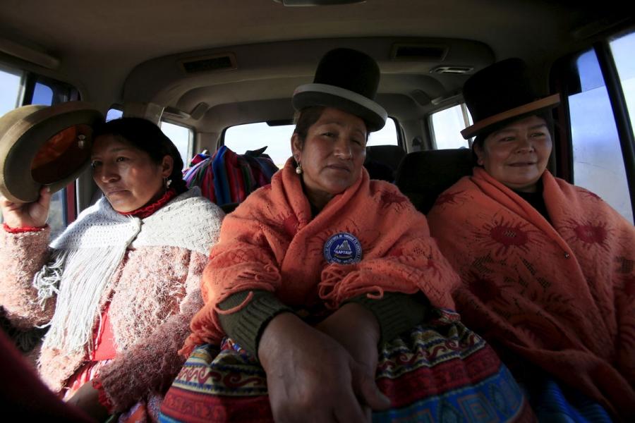 Bertha Vedia (L), Dora Magueno (C) and Lidia Huayllas sit in a car in El Alto.