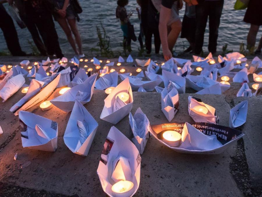 Hungarian protesters launch paper boats made out of pages of the biased questionnaire, to represent the lost lives of illegal migrants.