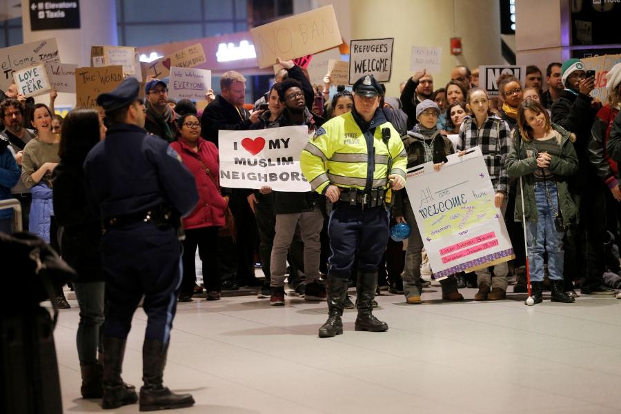 Demonstrators protesting President Donald Trump's executive order travel ban greet arriving passengers at Logan Airport in Boston.