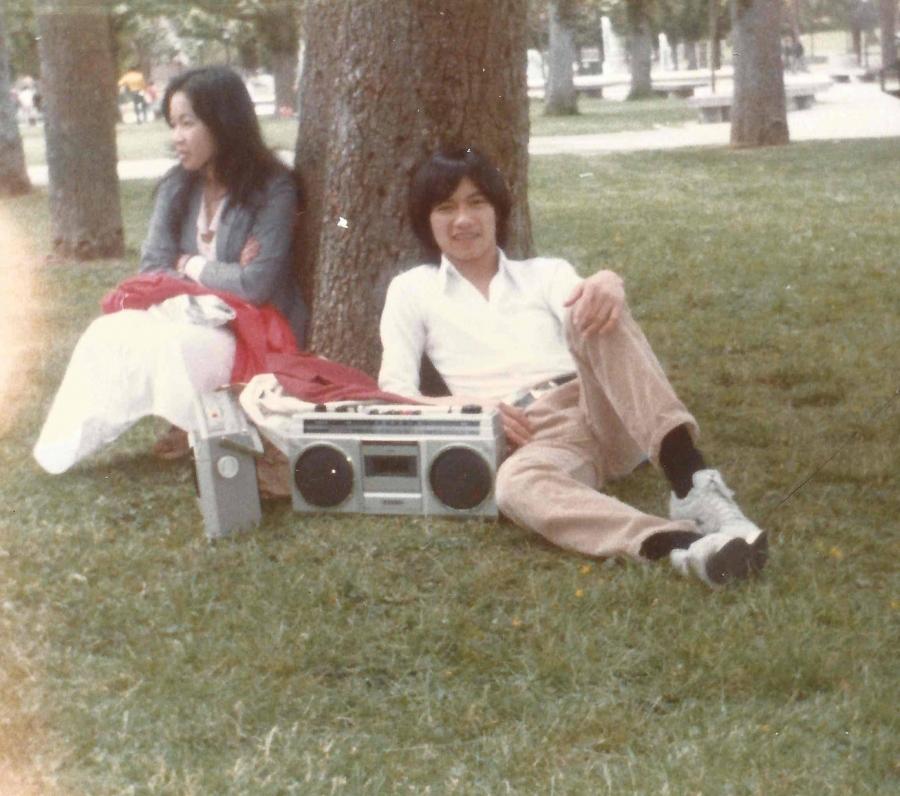 The author lounges by a tree next to his boombox, and an unidentified woman