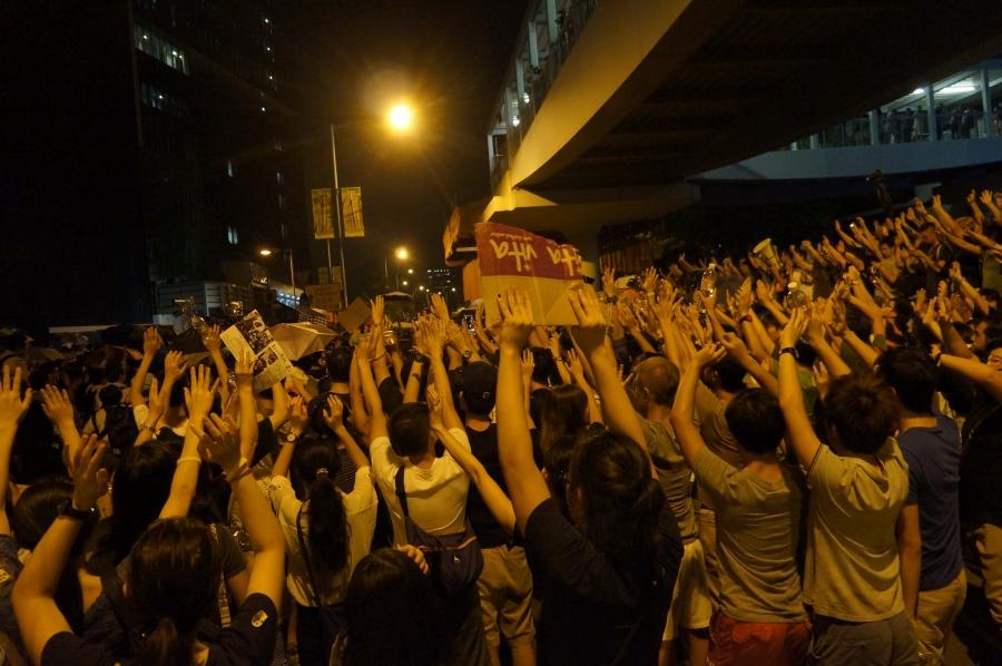 Protesters in Hong Kong raise their hands to show police that they are peaceful and unarmed during pro-democracy demonstrations over the weekend.