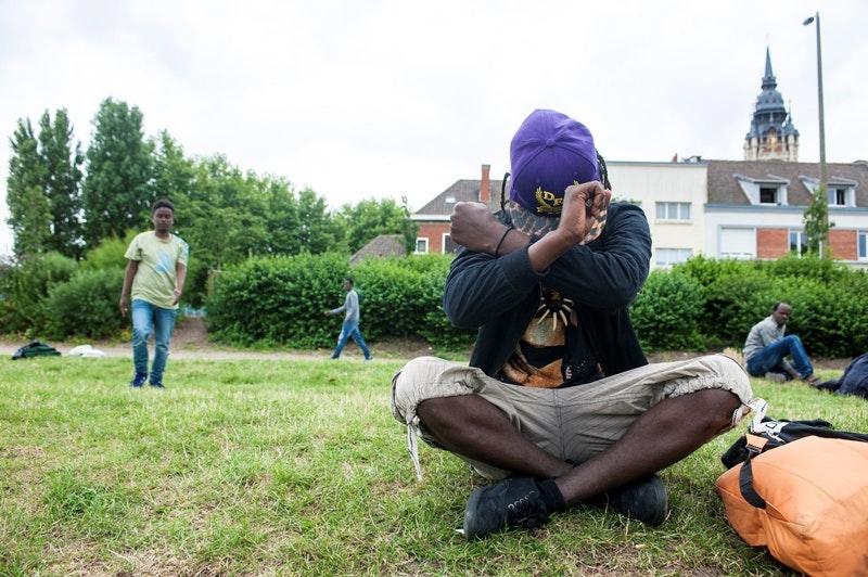 Jaamal, an 18-year-old Oromo refugee crosses his arms in front of his head to condemn the situation in Calais, July 26, 2017.
