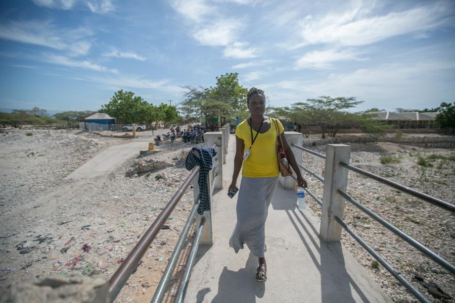 Project director Masani Accimé on a walkway crossing between Haiti and the Dominican Republic, where she has formed a rare cross-border relationship with a partner organization. Relations between the two countries have long been strained but Accimé says h