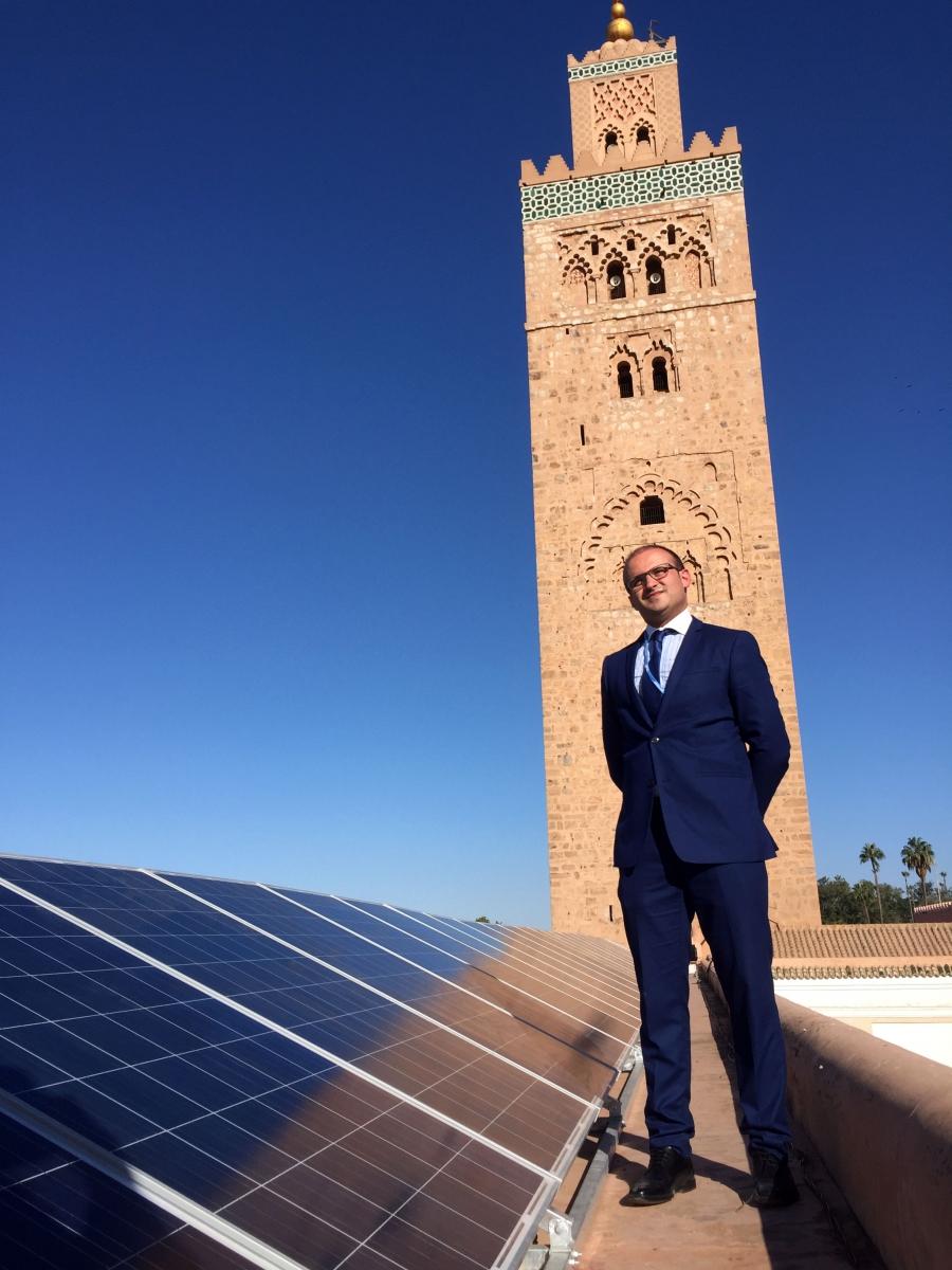 Ahmed Bouzid, head of energy efficiency for Morocco’s national energy investment company SIE, stands beside new photovoltaic panels on the roof of Marrakech's ancient Koutoubia mosque. It's one of 600 Moroccan mosques slated for similar