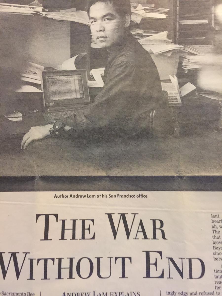 Newspaper clipping with photo of man, in black and white, sitting at desk and beginning of essay below