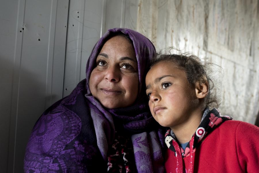 Um Ala said her youngest daughter Hala, 6, was not old enough to remember their home and farm in the rural outskirts of the southern Syrian city of Daraa. To remind her children of home, Um Ala shows photos of the house and their family. 