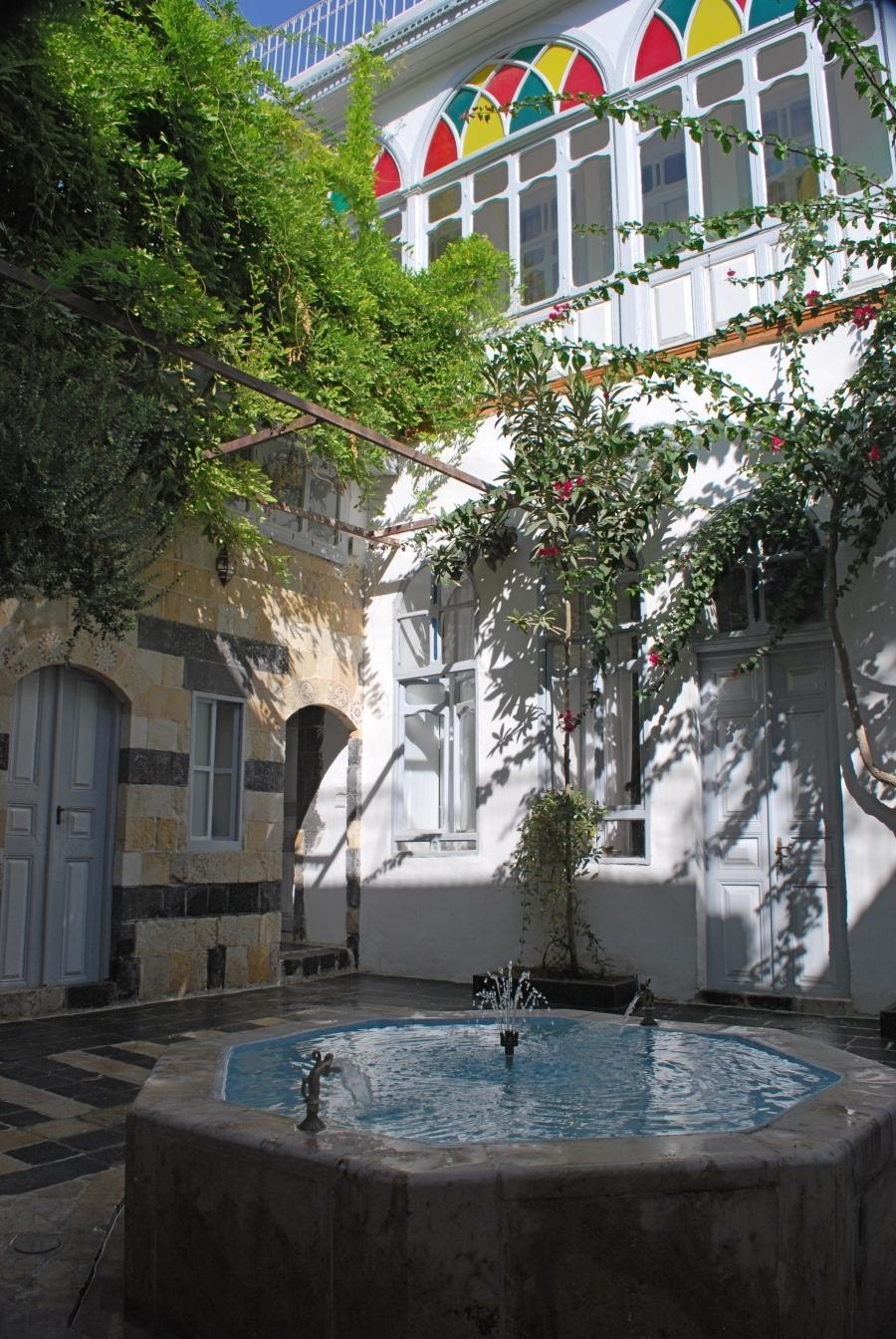 Bait Baroudi courtyard with fountain working, view towards the northern 19th century facade.