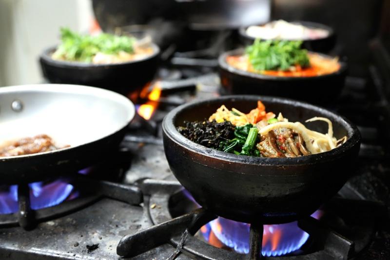 Many of the Korean dishes at Koreana are cooked and served in a hot stone bowl. Hyosun Tartaglia says her military customers who've served in Korea can handle her spiciest dishes. 