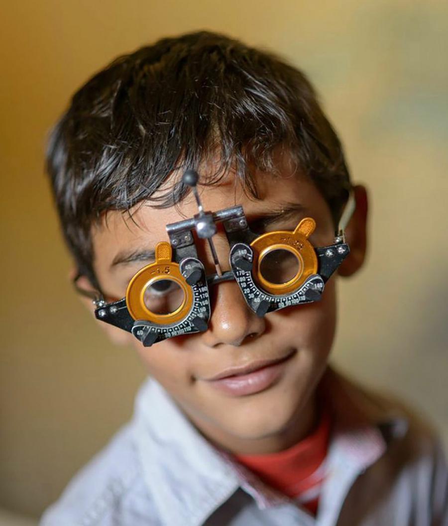 Boy takes a vision test, as part of VisionSpring's efforts to reach people in remote areas who need glasses.