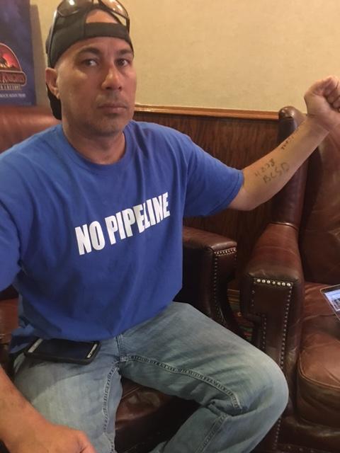 Dakota Access Pipeline protester Mekasi Camp-Horinek shows the numbers written on his arm after he was arrested for trespassing on land owned by the pipeline company next to the Standing Rock Reservation.