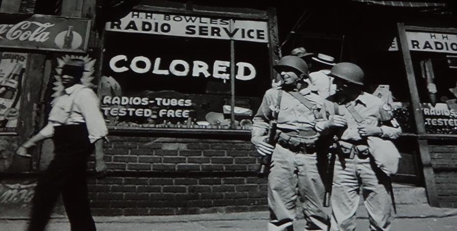 Street scene of GIs and African-American during World War II, from film at Rosie the Riveter Museum, Richmond, CA