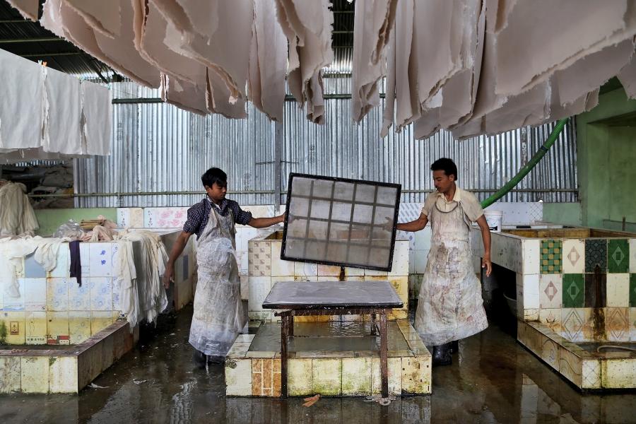 Workers at the Elrhino factory creating a sheet of rhino-dung paper. The sheets are used to make products such as decorative paper, lampshades, calendars and notebooks.