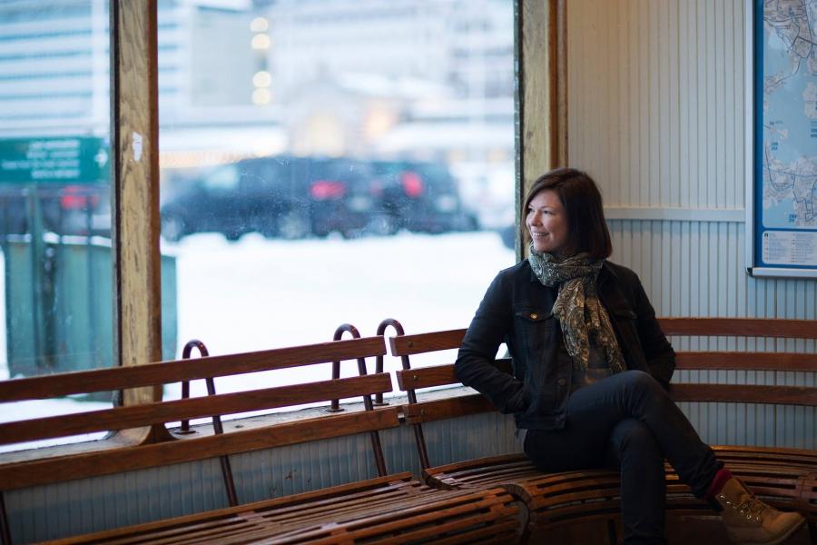 Anni Sinnemäki, a Green Party politician in Helsinki, sits at a tram stop.