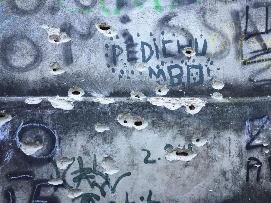 The walls of Rocinha alleyways are pockmarked with bullet holes.