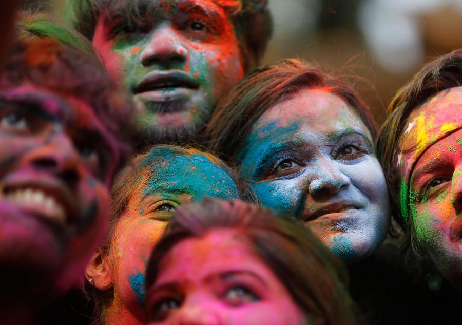 People pose for a selfie while celebrating Holi in India.